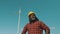 Young maintenance engineer african man with yellow hard hat helmet working in wind turbine farm