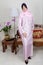 Young Malay woman in pink baju kurung,