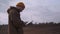 Young male agronomist working on the tablet in front of windmill in the field