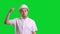 Young male angry engineer in white hardhat and shirt standing and knocking the helmet on green screen background