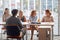 A young male applicant sitting in front of company commission at an interview. People, job, company, business concept