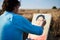 Young male artist, drawing portrait on canvas painting on wheat field in summer. Painting workshop in rural countryside. Artistic