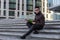 Young male Asian student sitting on steps of University read books and thought