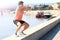 Young male athlete exercising by the Danube river at quay in Novi Sad, Serbia. Healthy lifestyle, outdoor running, sports concept.