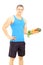 Young male athlete holding a dish full of fresh vegetables