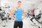 Young male athlete posing in a gym