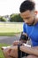 Young male athlete using fitness app on smartwatch, side view