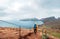 Young male backpacker hiking by footpath on Sao Lourenco headland with Atlantic ocean bay view in the end of February, Madeira