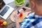 Young male biohacker taking photo of food