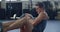 Young male bodybuilder doing core strength exercises for endurance and muscle toning in a training gym. Fit muscular