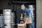 Young male brewer with keg at brewery warehouse and modern business industry