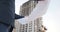 A young male builder architect inspects the construction of the building. An engineer looks at the drawings against the