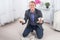 Young male businessman anger, hysterical kneeling on the floor, screaming and holding crumpled paper in his hands.