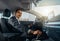 Young male businessman in a car rental service. Test drive concept. Blurred background