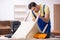 Young male carpenter repairing chair in the office