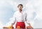 Young male chef standing near cooking table