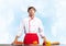 Young male chef standing near cooking table