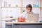 Young male chemist sitting at computer at the lab