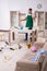 Young male contractor cleaning the flat after kids` party