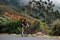 Young male cyclist practicing in wild terrain