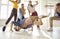 Young male dancer demonstrates his talent dancing breakdance in studio among other dancers.