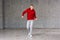 Young male dancer posing on studio background.