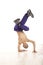 Young male dancer sitting on hands performing breakdance move