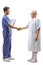 Young male doctor in a blue uniform shaking hands with an elderly male patient