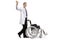 Young male doctor in a lab coat waving and pushing an empty wheelchair isolated