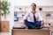 Young male employee doing yoga exercises during break