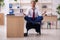 Young male employee doing yoga exercises during break