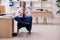 Young male employee doing yoga exercises during break