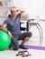 Young male employee exercising in the office