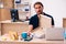 Young male employee ordering pizza at workplace