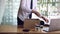 Young male employee standing near work table putting his stuff from in carton box belongings after being dismissed resignation