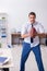 Young male employee throwing rugby ball in the office