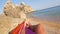 Young Male Feet Swinging in a Hammock on the Beach, POV. Relaxing Carefree Man Resting and Sunbathing near Beautiful Sea