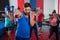 Young male and female athletes punching by boxing ring