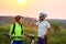 Young male and female cyclists stopped at the top of the hill and drink water in the summer