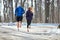 Young male and female jogging in nature, back view