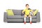 Young male football fan sitting on couch