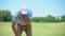 Young male golf player hitting ball, suffering terrible shoulder spasm, trauma