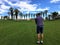 A young male golfer lining up his approach shot from the middle of the fairway on a par 4 on a golf course in Palm Springs