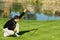 Young Male Golfer Lining Up Putt