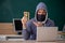 Young male hacker sitting in the classroom