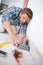 Young male handyman installing floor at clients home