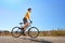 Young male with helmet riding a bike on a sunny day