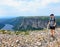 A young male hiker admiring the spectacular views from atop Gros Morne Mountain in Gros Morne National Park, Newfoundland