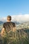 Young male hiker sitting on the summit of Diamond Head Crater in Honolulu on the Island of Oahu, Hawaii