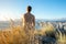 Young male hiker sitting on the summit of Diamond Head Crater in Honolulu, Oahu, Hawaii, looking down to Waikiki Beach